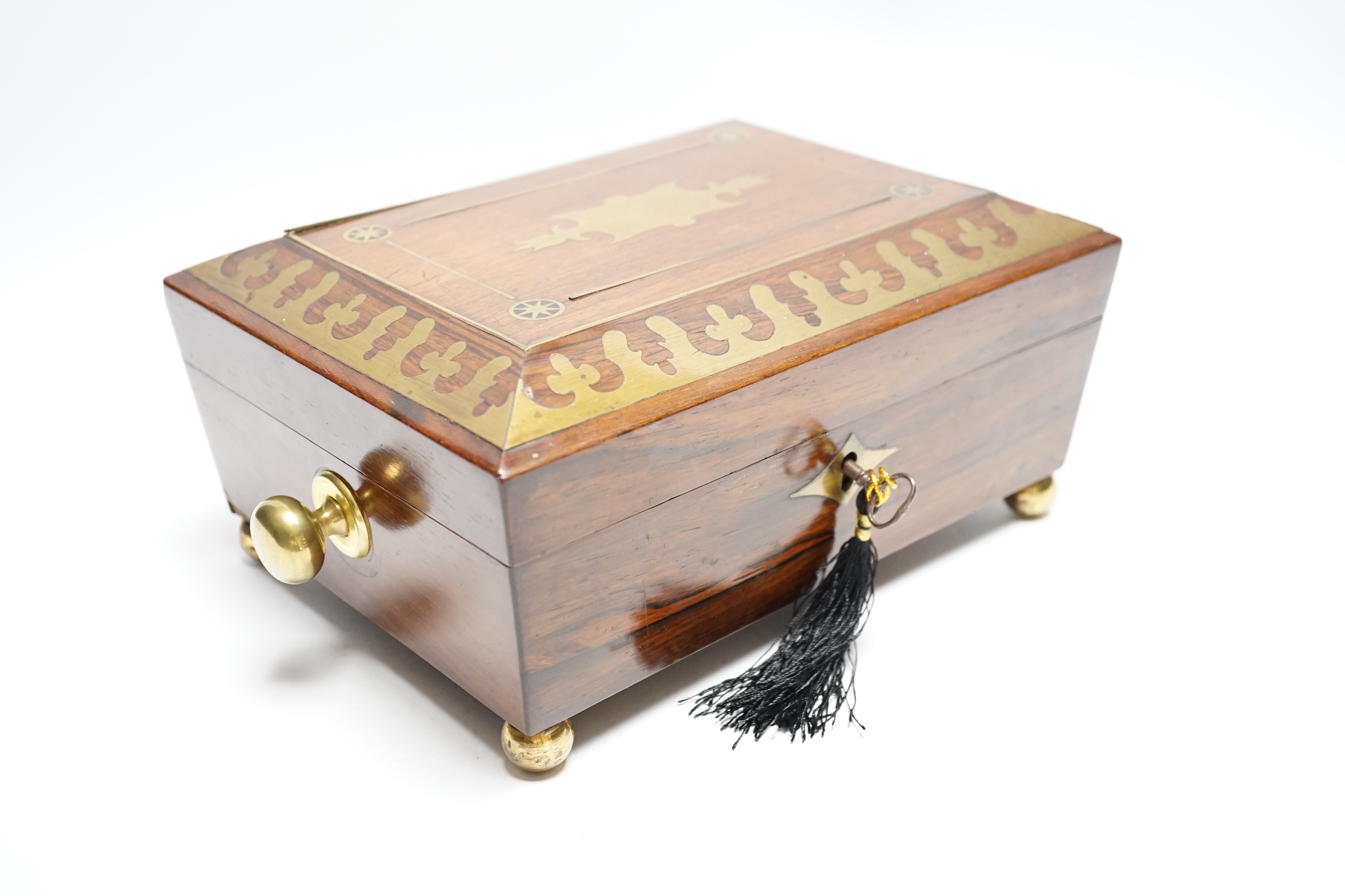 A George IV rosewood and cut brass sewing box with fitted interior, cotton reels, thread and sewing implements, 30cm wide